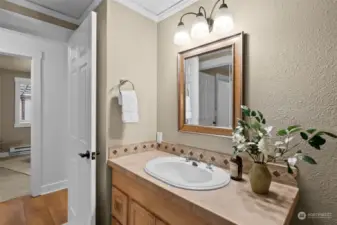 Full second bathroom with storage and tile surround above the tub!