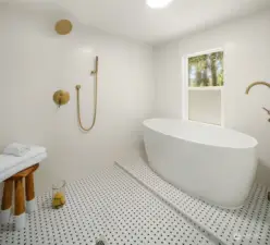 Exquisite bathroom on upper floor with shower and soaking tub