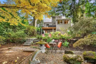 Beautiful terraced garden with rock retainer wall and mature plants/trees