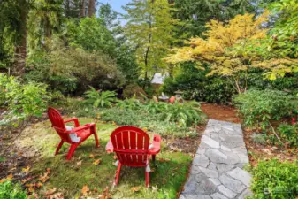 Beautiful terraced garden with rock retainer wall and mature plants/trees