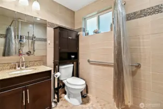 En suite bath with ADA accessible shower.