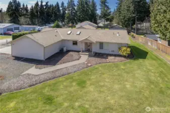 House has an attached garage. The 3-bay shop is beyond the house.