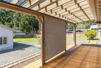 Covered deck has pull down sun shades as shown in the center section.