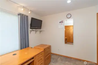 The mirror on the office wall conceals an ironing board.