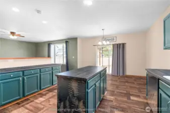 Kitchen dining area with sliding door access to backyard patio and ample natural light