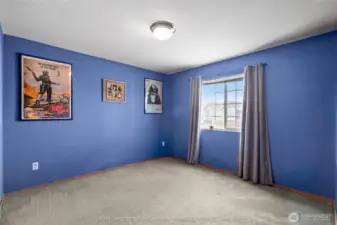 First bedroom with blue walls and good natural light
