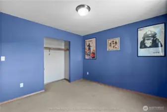 Alternate view of first bedroom showing closet, bright, open feel