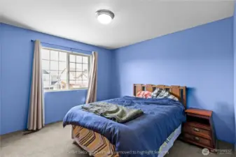 Second bedroom with vibrant blue walls and comfortable layout
