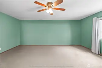 Primary bedroom detail with window treatments and ceiling fan