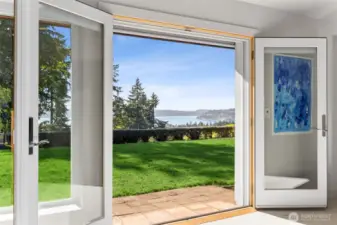 Graceful french doors lead to 3/4 acre estate grounds