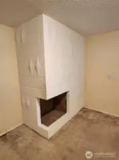 with the coolest fireplace, this room would make a perfect office or flex room