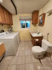 downstairs is a 1/2 bath, this is where you will find the washer and dryer