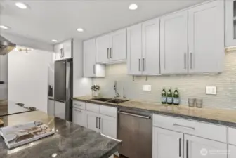 Bright and beautifully updated kitchen featuring sleek cabinetry, stone countertops, and generous prep space designed for both everyday living and effortless entertaining