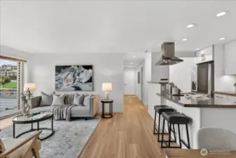 Light-filled open living and kitchen spaces create an inviting layout ideal for gathering, relaxing, and enjoying the surrounding waterfront setting