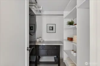 Dedicated utility room with laundry, counter space, and built-in shelving for additional storage.