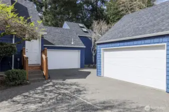 View of shared Garage and driveway. Shared Garage for Unit #6 is in the center side of the back Garage.
