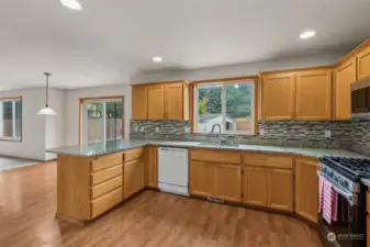 Lage kitchen with granite countertops and tile backsplash