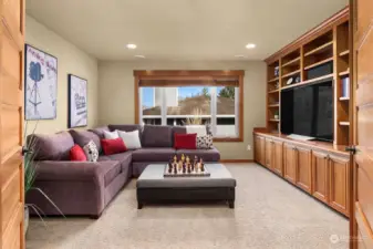 The upper-level bonus room features a wall of built-in cabinets and shelving, adding to the homes abundant storage space, and is equipped with surround sound speakers for movies, or to use as a game room or play room.  The Bonus room is accessible from a second staircase.