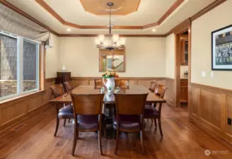 The large formal dining room carries all of the warm style and detail with shadow boxes and a coffered ceiling shown here providing a setting for elegant, special events and holidays with guests, friends and family.