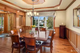 The large formal dining room carries all of the warm style and detail with shadow boxes and a coffered ceiling shown here providing a setting for elegant, special events and holidays with guests, friends and family.