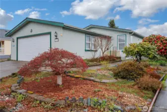 Welcome to Noble firs! Great floor plan tax records say 3 bedrooms but it is 2 bedrooms plus an office that could possibly be a 3rd bedroom, pretty landscaping, a good size two car garage that actually holds two cars inside! A covered walkway from the back of the garage to the home on the other side so you never need to carry your groceries in the rain! Tall vaulted ceilings throughout, skylights and large windows bring a ton of natural light in. Home includes a heat pump with a/c.