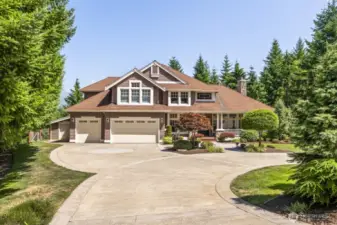 Oversized three-car garage includes a dedicated workshop area with built-in storage, plus a separate toy garage—perfect for all your gear and adventure vehicles.