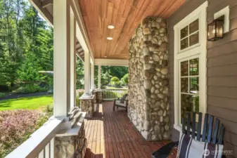 Expansive and beautiful wrap-around porch extends along two sides of the home.
