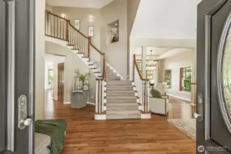 Soaring ceilings and walls of custom wood-framed windows welcome you into the light-filled foyer.