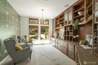 Stunning library/office off the foyer with French doors, custom built-ins & blinds, designer wallpaper and new carpet.