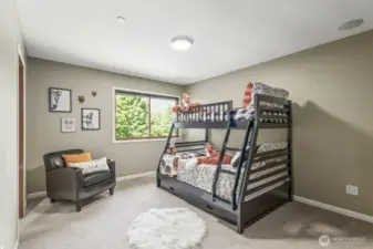 One of the four inviting bedrooms, this suite features its own private ensuite bath & walk-in-closet with custom built-ins for added comfort and convenience.