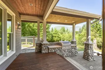 Just off the kitchen & nook, a covered patio with built-in gas grill offers effortless outdoor entertaining.