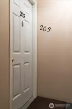 Short walk down hallway, off elevator, leads to entrance of this lovely condominium