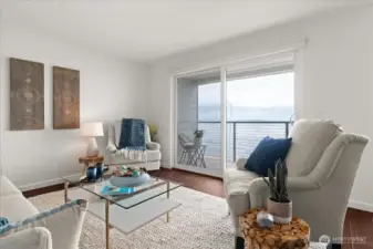 Generous great room with sliding glass door, offering access to private, covered deck