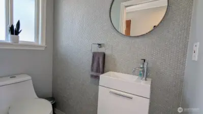 Charming 1/2 Bathroom, off living room with ceramic penny tiles!