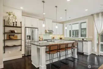 Gourmet kitchen open to eating and living areas