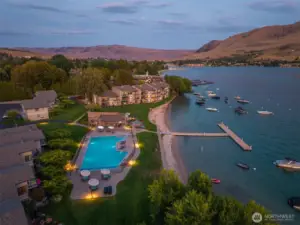 Aerial view 6 of Spader Bay property with Olympic-sized pool, grassy lawn, sandy beach, waterfront, T-dock and mooring buoys.