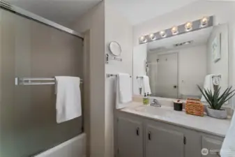 Bathroom 1 with bath and shower and large vanity.