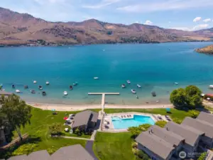 Aerial view of Spader Bay and waterfront with Olympic sized pool, clubhouse, T-dock, sandy beach and mooring buoys.