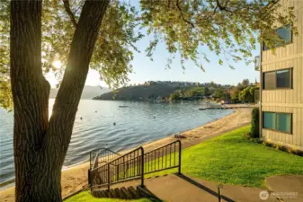View of waterfront, sandy beach and landscaped grounds.