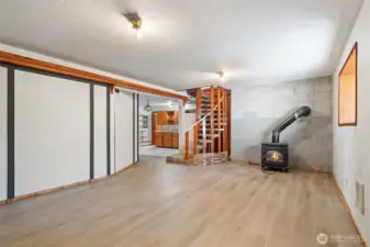 Lower floor family room with free standing natural gas stove.