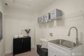 Full size laundry room conveniently situated between bedrooms for easy living