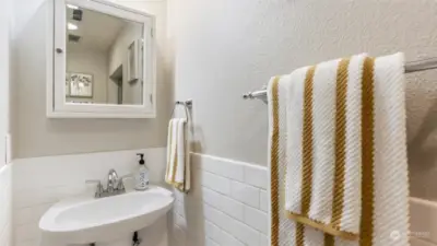 Bathroom if light and bright and has storage mirror to keep your things tucked away
