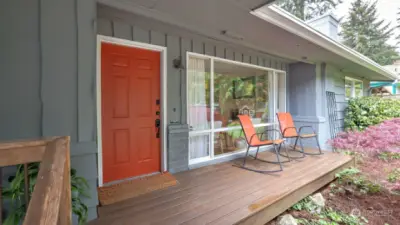 Easy maintenance Trex deck and a vibrant colored front door for added character.