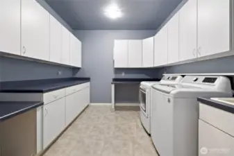 Laundry room next to the garage entrance and a guest bath