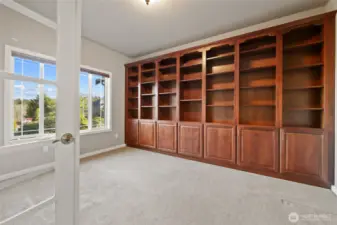 Stunning floor to ceiling rich wood book shelves