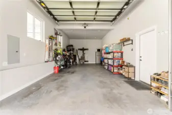 Interior view of attached garage w/ oversized doors.