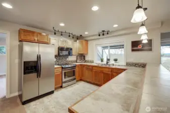 Daylight basement has full sized kitchen with raised bar top. All appliances stay!