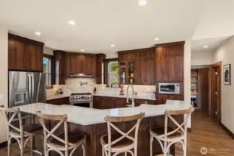 1/2 bath off kitchen and large walk-in pantry with custom cabinetry