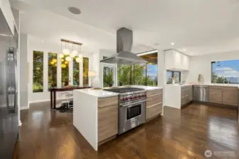 A premium Wolf range, oven, and hood on a generously sized island, with ample space for cooking and prepping all around.