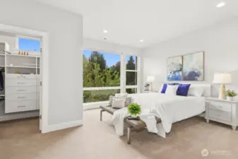 Spacious primary suite with walk in closet and floor to ceiling windows